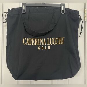 Caterina Lucchi Gold drawstring dust bag handle tote bag.